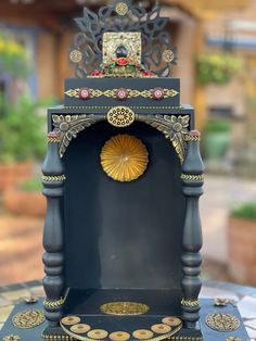 a clock that is sitting on top of a blue table with gold trimmings