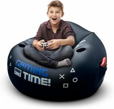 a boy sitting on an inflatable gaming time bean bag chair holding a game controller