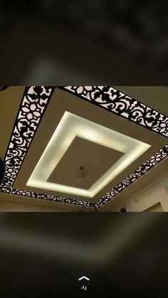 the ceiling in this room is decorated with black and white designs, including an intricate design