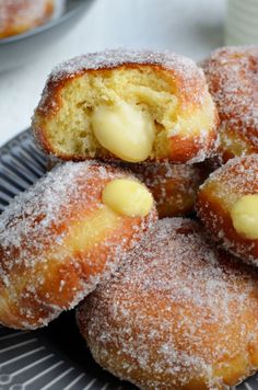 powdered sugar covered doughnuts on a plate