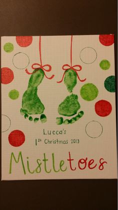 a handprinted christmas card with two green hands hanging from red and green balls