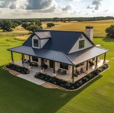 an aerial view of a house in the middle of a field