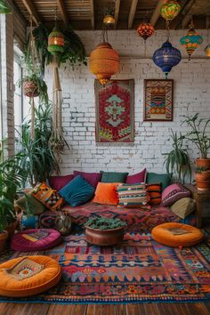 a living room filled with lots of colorful pillows and rugs on top of a wooden floor