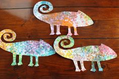 three paper mache animals sitting on top of a wooden table