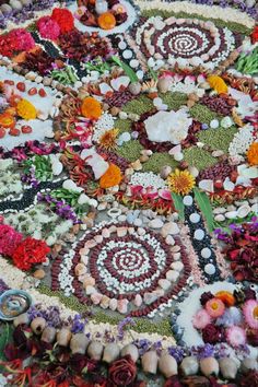 an elaborately designed table cloth with flowers and stones on it's surface,