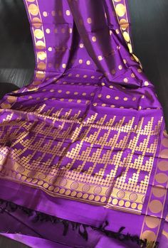 Beautiful handloom Kanjivaram  pure silk saree in purple shade with zari buttas all over the body. Buttas are woven in different sizes and when worn, makes one look taller because of the vertically woven buttas.A very retro style unique saree.  Saree comes with an unstitched blouse piece  Colour may vary slightly due to lighting  Handloom products may have slight irregularities unlike powerloom products No falls or pico done All sales are final. *Dry clean only Purple Banarasi Silk Traditional Wear For Puja, Purple Katan Silk Traditional Wear For Puja, Purple Katan Silk Traditional Wear For Diwali, Diwali Purple Katan Silk Traditional Wear, Purple Paithani Silk Handloom Traditional Wear, Purple Paithani Silk Saree With Zari Weaving, Festive Purple Katan Silk Saree, Purple Traditional Wear With Zari Weaving For Festivals, Purple Banarasi Silk Handloom Saree