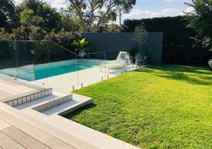 an empty backyard with a pool and stairs