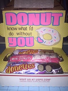 an open donut box filled with doughnuts and candy