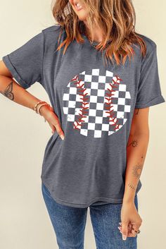 a woman wearing a t - shirt with a checkered baseball design on the front