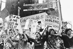 black and white photograph of protestors in new york city, with one woman holding up signs