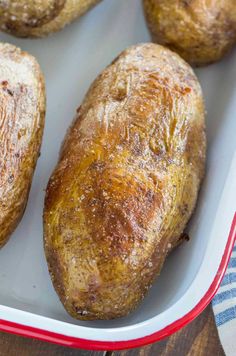 baked potatoes in a red and white dish