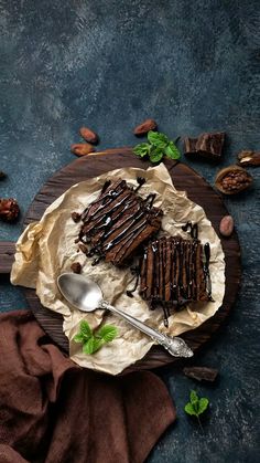 there is a piece of chocolate cake on the plate with a spoon next to it