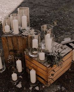 a wooden crate filled with lots of white candles