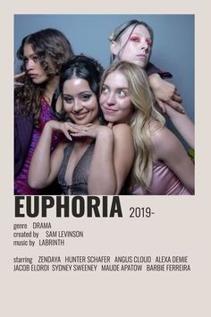 a group of women standing next to each other in front of a poster with the words euphora on it