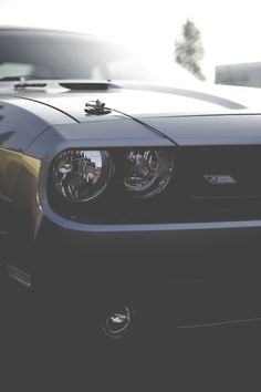 the front end of a black sports car