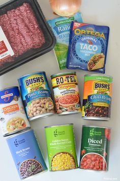 an assortment of canned food items including meat, beans, rice and other foodstuffs