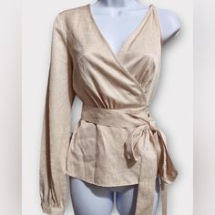 This Bcbgmaxazria Wrap Top Features A Single Long Sleeve, An Adjustable Shoulder Strap And A Tie Closure At The Waist. Style V-Neck; Tie Closure At The Waist Brand: Bcbgmaxazria Size: Xxs Condition: New With Tags. Color: Beige Pattern: Solid Material: 60% Viscose, 40% Polyester Care: Hand Wash Approx. Measurements (Flat): Bust: 17" Sleeve: 25" Length: 25" Across The Bottom: 21" Beige Long Sleeve Blouse For Brunch, Spring Formal Wrap Blouse, Spring Season Formal Wrap Blouse, Spring Glamorous Formal Blouse, Beige V-neck Tops For Formal Occasions, Chic Long Sleeve Wrap Top For Formal Occasions, Elegant Long Sleeve Wrap Top, Spring Formal Wrap Top, Formal Beige V-neck Tops