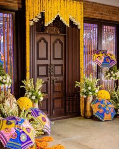 an entrance decorated with flowers and decorative umbrellas