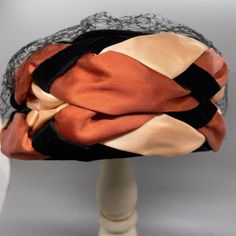 This fabulous hat has Black Velvet with Rust and Peach Satin Braided Around the Sides.  The tag from this hat has been removed. Maker is unknown The hat needs some reshaping. This will start with my packing the hat, but may need more once I arrives to you.  There is no damage other than one small hole in the netting - Last picture Sides are 3 1/2 inches 22 inches around lower brim 7 x 7 14 inches across bottom of hat.  Photo props are not for sale.  Please see the photos for the best description. Ask if you would like more pictures or information. We want you to know exactly what you are getting before it arrives at your door. By Purchasing any item in my shop, you are agreeing that you read the full description including photos.  If you are buying more than one item from my shop, I will c Large Brim Hat, Hat Photo, Types Of Hats, Pillbox Hat, Pill Boxes, Not For Sale, Black Velvet, Fascinator, Photo Props