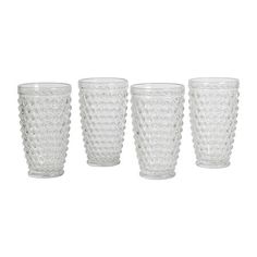 four clear glass tumblers sitting next to each other