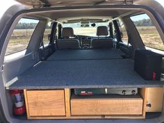 the back end of a van with an open trunk and entertainment system in it's cargo area