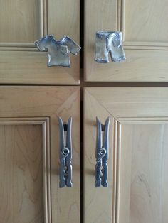 two pairs of metal handles on wooden cabinets