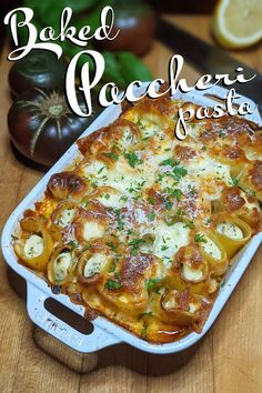 baked macaroni and cheese casserole in a white dish on a wooden table