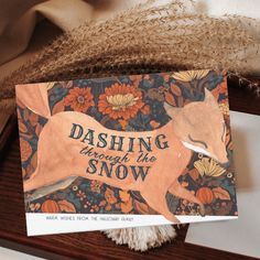 a card with the words dashing through the snow on it and an image of a fox