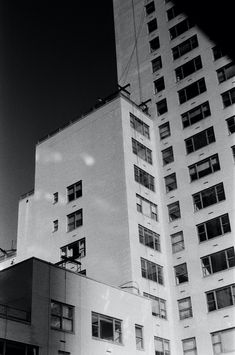 a black and white photo of an apartment building