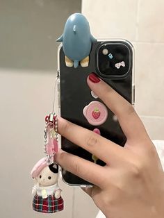 a person holding a cell phone up to their ear with some buttons on the back