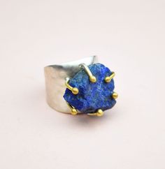 Natural Rough Lapis Lazuli Ring, Statement Gemstone Ring, Chunky Ring For Woman, Big Gemstone Ring, Handmade Adjustable Ring, Gift For Her Gemstone: Genuine Lapis Lazuli. Birthstone: (February 19 - March 19). Zodiac: Sagittarius. Chakra: Third Eye, Throat. Lapis Lazuli is a crystal of truth in all aspects. It reveals inner truth, and promotes self-awareness and the acceptance of that knowledge. Use the drop down list to select the color finish you prefer (plain silver, yellow gold). ⚜️Weight: 11 Lapis Lazuli Gemstone Ring Jewelry, Handmade Lapis Lazuli Ring, Lapis Lazuli Gemstone Ring, Unique Blue Jewelry With Raw Stone, Unique Blue Raw Stone Jewelry, Rough Gemstone Ring, Layered Pearl Necklace, Lapis Ring, Chunky Ring