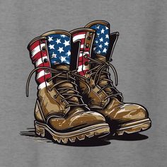 a pair of boots with the american flag painted on them, sitting in front of a gray t - shirt