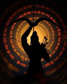 the silhouette of a person holding a bow and arrow in front of a circular background