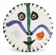 a paper plate with a face painted on it