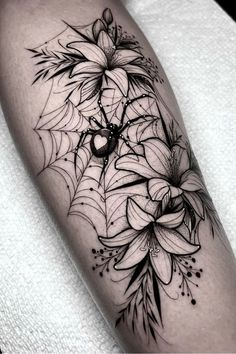 a black and white flower tattoo on the leg