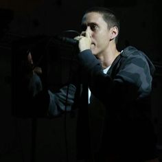 a man holding a microphone up to his face