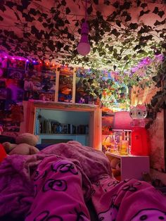 a bedroom with purple sheets and lights hanging from the ceiling over it's bed