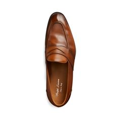 The Meegan’s chiseled profile and artisanal construction speak to its Italian provenance. Crafted from burnished calfskin for a rich depth of color it's finished with hand-stitching at the vamp and the heel. Classic Brown Loafers Medium Width, Semi-formal Moc Toe Calf Leather Loafers, Men’s Penny Loafers, Brown Crocodile Pattern Loafers For Semi-formal Occasions, Brown Loafers With Rubber Sole, Medium Width, The Vamps, Penny Loafers, Penny, Calf Skin