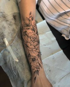 a person with a flower tattoo on their arm