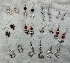 These assorted Gothic cats and angel earring sets are handcrafted personally for me, Derlis. There are 11 different styles for you to choose from. Perfect gift for friends, family and love ones for Mardi Gras parade/costume, Halloween &/or Dia de los muertos parties/season. MATERIALS:   - Rhodium finish fishhook earwires - Grey Shell heart bead 10mm - Czech glass seed bead 6/0 (approx. 2-4mm): pearl white. - Glass see bead 6/0 (approx. 2-4mm): Black - Crystal AB drop silver tone charm  - Ceramic Gothic Cats, Black Cat Earrings, Shell Heart, Mom Earrings, Mardi Gras Parade, Heart Cat, Angel Earrings, Halloween Charms, Earring Sets