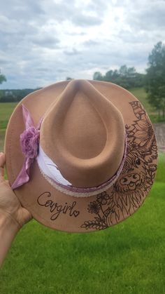 a person holding up a brown hat in front of their face with the words cacilio written on it