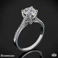 a white gold engagement ring with an oval cut diamond and side stones on the band