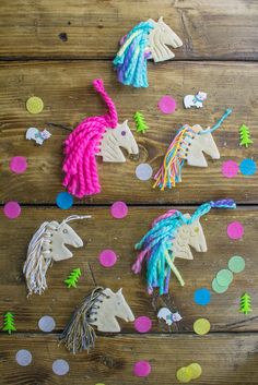 the unicorns are made out of yarn and decorated with confetti on the table