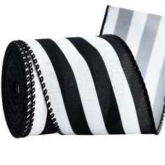 a roll of black and white striped ribbon on top of each other with zippers