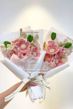 two bouquets of flowers are wrapped in white paper