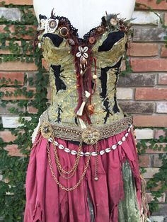 a corset is shown on a mannequin in front of a brick wall