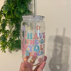 a person holding up a clear tumbler with the words have you ever written on it