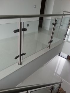 an empty room with glass railings and white walls