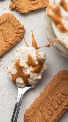 spoon with ice cream and caramel drizzled on top of peanut butter cookies