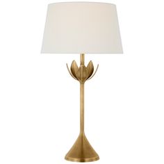 a gold lamp with a white shade on it